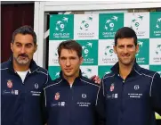  ?? — AP ?? Serbian Davis Cup team members pose after the draw.