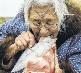  ?? KAITLYN VAN DE WOESTYNE ?? Bessie Omilgoetok of Cambridge Bay, Nunavut, cleans the blubber from a seal pelt with her ulu. Canada is renowned for its multicultu­ralism, yet a still unsettled issue in Canadian multicultu­ralism pertains to languages.