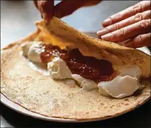  ??  ?? Thin, crepe-like Dutch pancakes are rolled around a mixture of yogurt and marmalade.