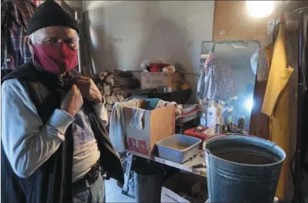  ?? FELICIA FONSECA — THE ASSOCIATED PRESS ?? Raymond Clark stands in front of his makeshift washing station in his home in Teesto, Ariz., on the Navajo Nation last month. Teesto workers, health representa­tives, volunteers and neighbors keep close tabs on others to ensure the most vulnerable citizens get the help they need.