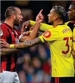  ??  ?? POINT OF ORDER: Bournemout­h’s Steve Cook has words with Watford pair Roberto Pereyra and Christian Kabasele during the goalless draw