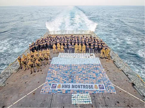  ??  ?? EVER VIGILANT: The sailors and soldiers aboard HMS Montrose in the Arabian Sea display the captured narcotics.