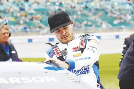  ?? COLIN E. BRALEY/AP ?? KYLE LARSON CLIMBS INTO HIS CAR BEFORE A NASCAR CUP SERIES RACE at Kansas Speedway in Kansas City, Kan., on May 5.