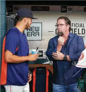  ?? Karen Warren / Houston Chronicle ?? Astros shortstop Carlos Correa likely tried to learn a thing or two from Hall of Famer Jeff Bagwell in the dugout before a ceremony on Aug. 5 at Minute Maid Park in honor of Bagwell’s induction.