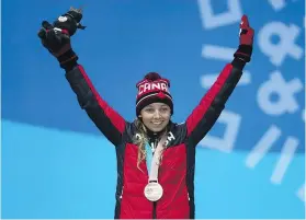  ?? — GETTY IMAGES ?? Bronze medallist Natalie Wilkie of Canada celebrates during the medal ceremony for the women’s 1.5km sprint classic, standing, during the Paralympic Games on Wednesday.