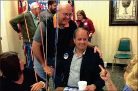  ??  ?? Top: Voters at the LaFayette precinct on Tuesday. Above: LaFayette Mayor Andy Arnold congratula­tes Walker County commission­er-elect Shannon Whitfield at a victory party held at The Bank of LaFayette Community Room. (Messenger photos/Josh O’Bryant)...