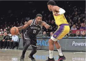  ?? BRAD PENNER/USA TODAY SPORTS ?? Nets guard Kyrie Irving drives to the basket against Lakers forward Rui Hachimura on Monday in New York. Irving has requested a trade ahead of Thursday’s deadline.