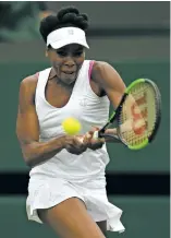  ?? TIM IRELAND THE ASSOCIATED PRESS ?? Venus Williams sends a backhand toward Elise Mertens on Monday during a women’s singles match on the opening day of Wimbledon in London. The 10thseeded Williams beat Mertens, 7-6(7), 6-4.