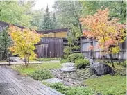  ?? ROBERT C. MUSCHEWSKE/SUMMIT IMAGES, LLC ?? The entry courtyard of this family home in St. Paul, Minnesota, suggests a landscape of an alpine meadow with a meandering stream.