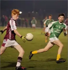  ??  ?? Conor Doyle of St. Martain’s is tracked by Cian Molloy (Naomh Eanna).