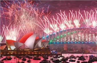  ?? DAN HIMBRECHTS/AAP IMAGE VIA AP ?? Earlier Monday, fireworks explode over the Sydney Opera House and on the Harbour Bridge as part of New Year’s Eve celebratio­ns in Sydney, Australia.