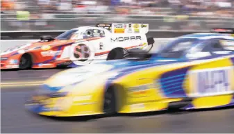  ?? D. Ross Cameron / Special to The Chronicle ?? Matt Hagan (left) and Ron Capps run neck and neck in the Top Fuel/Funny Car competitio­n.