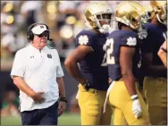  ?? AJ Mast / Associated Press ?? Notre Dame head coach Brian Kelly walks to a huddle during Saturday’s win over Toledo in South Bend, Ind.