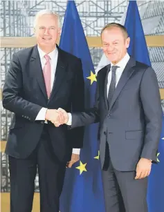  ?? — Reuters photo ?? Barnier is welcomed by Tusk prior to a meeting in Brussels, Belgium.