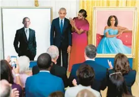  ?? ANDREW HARNIK/AP ?? Former President Barack Obama and former first lady Michelle Obama unveil their official White House portraits Wednesday in a ceremony in the East Room.