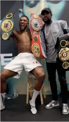  ??  ?? LITTLE AND LARGE: Mayweather and Joshua celebrate