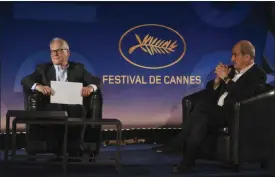  ??  ?? Cannes Festival director Thierry Fremaux, left, and festival president Pierre Lescure present the festival lineup in an empty cinema.