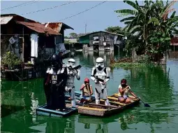  ??  ?? ABOVE LEFT: In Manila, youth workers dressed as Star Wars characters to encourage lockdown. ABOVE RIGHT: Muhammad Urabil, the lockdown phantom of Kemaman village.