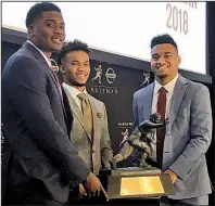  ?? AP/RALPH RUSSO ?? Heisman Trophy finalists (from left) Dwayne Haskins (Ohio State), Kyler Murray (Oklahoma) and Tua Tagovailoa (Alabama) pose with the Heisman Trophy at the New York Stock Exchange on Friday in New York. A quarterbac­k will win college football’s most coveted individual award for the 16th time in the past 19 years.