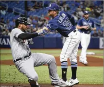  ?? DIRK SHADD/TAMPA BAY TIMES ?? New Braves outfielder Jordan Luplow, tagging out the Tigers’ Jonathan Schoop while he was with the Rays in 2021, has played for Pittsburgh, Cleveland, Tampa and Arizona.