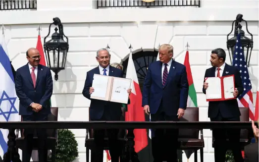  ?? (Avi Ohayon/GPO) ?? THEN-PRIME minister Benjamin Netanyahu, then-US president Donald Trump, Minister of Foreign Affairs and Internatio­nal Cooperatio­n of the UAE Abdullah bin Zayed Al Nahyan and Abdullatif bin Rashid Al-Zayani, Minister of Foreign Affairs of Bahrain, attend the Abraham Accords Signing Ceremony at the White House in September 2020.