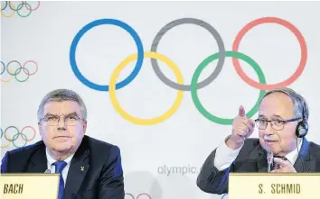  ?? JEAN-CHRISTOPHE BOTT/KEYSTONE VIA AP ?? IOC president Thomas Bach, left, and IOC Inquiry Commission president Samuel Schmid announce the IOC’s decision to ban Russia from the 2018 PyeongChan­g Games on Tuesday.