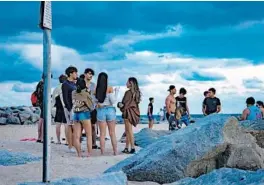  ?? FLORIDA SUN SENTINEL
JENNIFER LETT/SOUTH ?? Young people drink and party at the beach in Fort Lauderdale on Jan. 30.