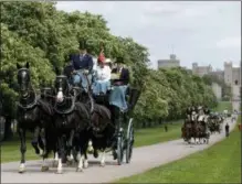  ??  ?? Horse-drawn carriages make their way down the Long Walk from Windsor Castle in Windsor, England, Friday.