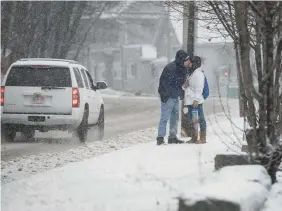  ?? ASHLEY GREEN/WORCESTER TELEGRAM & GAZETTE ?? A couple kiss in a December snow in Fitchburg, Mass. In Boston, temperatur­es were the seond highest in history.