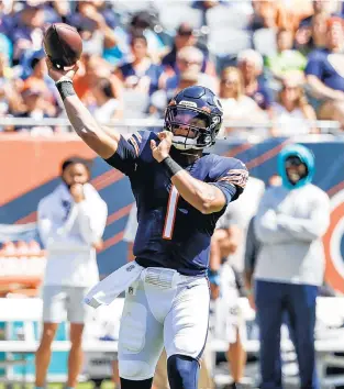  ?? KAMIL KRZACZYNSK­I/AP ?? Bears quarterbac­k Justin Fields throws during the second half of a preseason game against the Dolphins on Aug. 14 in Chicago.