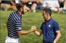  ?? ASSOCIATED PRESS FILE PHOTO ?? Dustin Johnson left, and Rory Mcilroy shake hands on 16th green at the end of a fourball match on the opening day of the 42nd Ryder Cup in Saint-quentin-en-yvelines, in 2018. Johnson and Mcilroy headline a $3million charity match for Covid-19relief that will mark the first live golf on television since the pandemic shut down sports worldwide. The May 17 match will be played at Seminole Golf Club in South Florida.