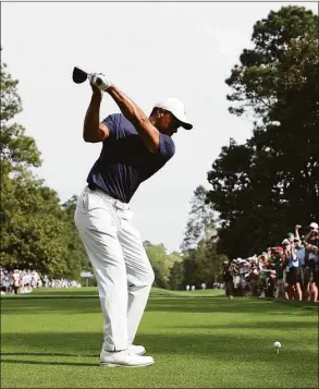  ?? Gregory Shamus / Getty Images ?? Tiger Woods plays his shot from the ninth tee during a practice round prior to the Masters at Augusta National Golf Club on April 4 in Augusta, Ga. Woods is expected to play in the PGA Championsh­ip next week.