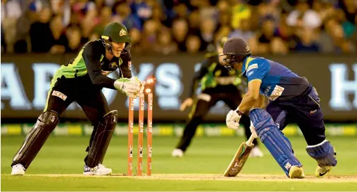  ?? AFP ?? Australia’s wicketkeep­er Tim Paine (left) stumps Sri Lanka’s Asela Gunaratne during their first Twenty20 match in Melbourne on Friday. —