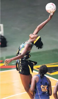  ?? RICARDO MAKYN/MULTIMEDIA PHOTO EDITOR ?? Jamaica’s Shimona Nelson goes high to collect a pass while being closely watched by Barbadian Shonette Azore-Bruce during last night’s netball ‘Test’ at the National Arena.