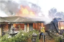  ?? AP ?? Trabajo. Bomberos trabajan en la extinción del fuego en una casa, durante las devastacio­nes en Anaheim Hills, ayer en California.