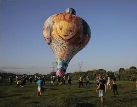  ?? Photograph: Alan Lima/The Guardian ?? Balloon enthusiast­s, known as baloeiros, rise before dawn to launch their creations at the annual event.