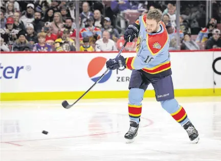  ?? ALIE SKOWRONSKI askowronsk­i@miamiheral­d.com ?? Panthers center Aleksander Barkov takes a shot during the accuracy competitio­n during the NHL All-Star Skills Competitio­n on Friday at FLA Live Arena in Sunrise. Barkov finished eighth, taking 25.297 seconds to hit the four targets after shattering one on his first shot.