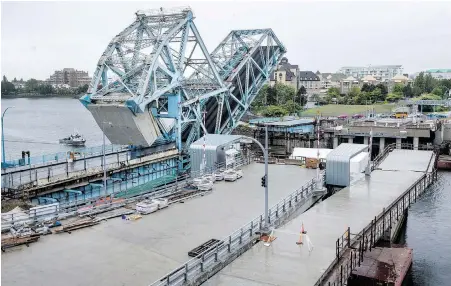  ??  ?? Old and new bridges, side by side: The existing Johnson Street Bridge, which opened in 1924, rises beside its replacemen­t, now scheduled to open on March 30, 2018. The new bridge has been delayed by metal-fabricatio­n problems in China.