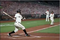  ?? KARL MONDON — BAY AREA NEWS GROUP, 2020 ?? The San Francisco Giants’ Brandon Belt hits a single scoring Donovan Solano from third base in the first inning against the Seattle Mariners at Oracle Park on Sept. 8.