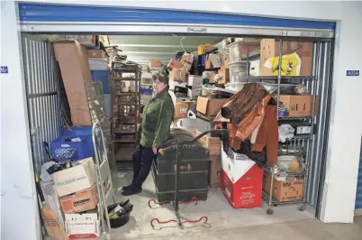  ?? SENTINEL MICHAEL SEARS/MILWAUKEE JOURNAL ?? Alice Donohoe, who downsized from a large Glendale home after raising her 10 children, looks over the items in her 40-foot-by-10-foot storage unit at U.S. Storage Depot, 4200 N. Holton St.