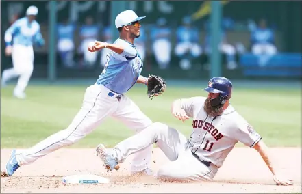  ??  ?? Houston Astros’ Evan Gattis (11) is out at second base as Kansas City Royals shortstop Alcides Escobar (2) throws to first for an inning-ending double
play during a baseball game at Kauffman Stadium in Kansas City, Mo, on June 17. (AP)