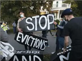  ?? MICHAEL DWYER — THE ASSOCIATED PRESS FILE ?? Housing activists erect a sign in Swampscott, Mass., in October. A federal freeze on most evictions is set to expire soon. The moratorium, put in place by the Centers for Disease Control and Prevention in September, was the only tool keeping millions of tenants in their homes.