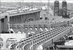  ?? Associated Press ?? The steel skeleton for the eastern end of the new Innerbelt Bridge in Cleveland sits next to the existing span May 17, 2012. The House on Thursday voted overwhelmi­ngly in favor of final passage of a five-year, $305 billion bill that boosts highway and...