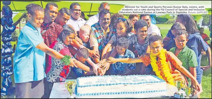  ?? Picture: SUPPLIED ?? Minister for Youth and Sports Parveen Kumar Bala, centre, with students cut a cake during the Fiji Council of Special and Inclusive Educators National Games at Lawaqa Park in Sigatoka.