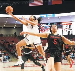  ?? David J. Phillip / Associated Press ?? UConn’s Megan Walker goes up for a shot as Houston’s Dymond Gladney runs past during the first half on Saturday in Houston.