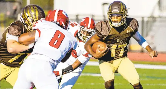  ?? APRILGAMIZ/THE MORNING CALL ?? Bethlehem Catholic’s Jared Richardson (17) looks for a touchdown against Easton on Saturday at Bethlehem Area School District Stadium.