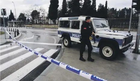  ?? Reuters ?? Police guard the US embassy building in Podgorica, Montenegro, after the grenade attack