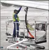  ?? AJC FILE 2019 ?? A Delta ground crew prepares a plane for departure. The airline released a climate lobbying report Tuesday to comply with investor requests.