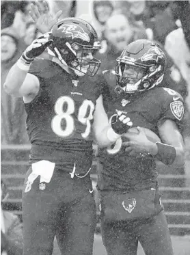  ?? KARL MERTON FERRON/BALTIMORE SUN ?? Ravens quarterbac­k Lamar Jackson celebrates his touchdown against the 49ers with tight end Mark Andrews during the second quarter Sunday.