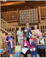  ?? (Special to The Commercial) ?? Grand Prairie Quilt Society members display works at the Cross Heirs Retreat Center.